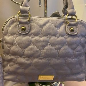Besty Johnson lavender purse. Handles on top and crossbody strap.